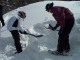 Keep digging straight down so you have a place to stand when you dig into the hill.