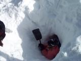 Taking snow out of the cave.