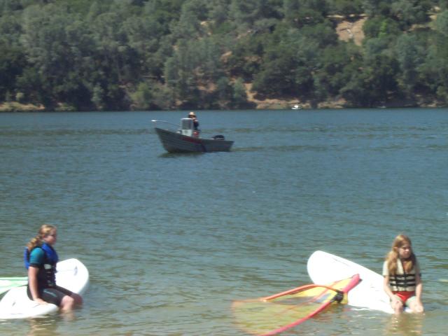 The life guard in a boat can lend a hand.